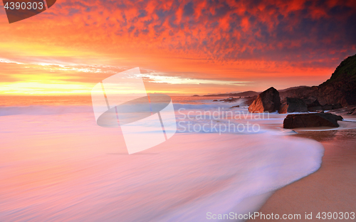 Image of Foamy white seas and vivid sunrise