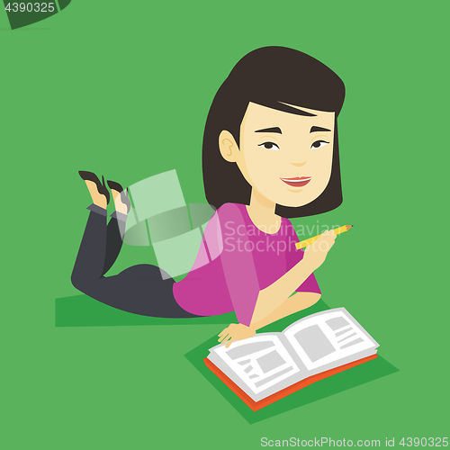 Image of Student laying on the floor and reading book.