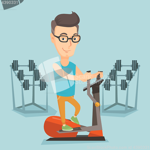 Image of Man exercising on elliptical trainer.