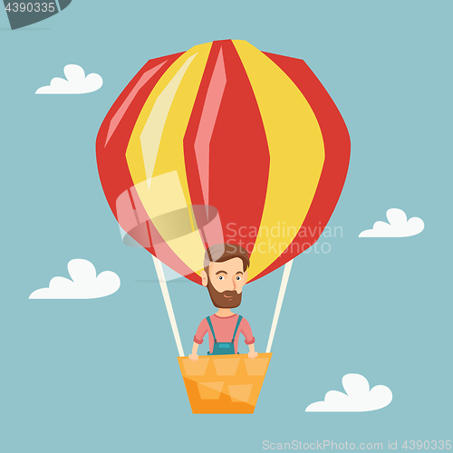 Image of Young man flying in hot air balloon.