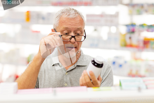 Image of senior male customer with drug at pharmacy