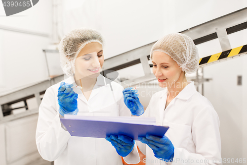 Image of women technologists tasting ice cream at factory