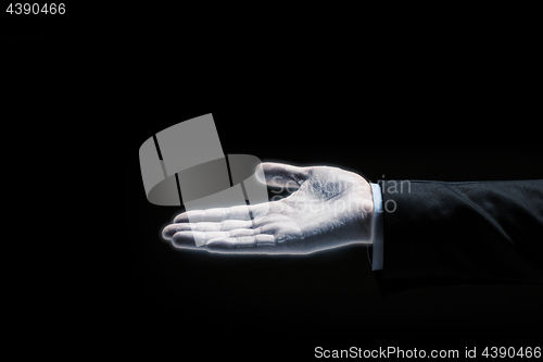 Image of glowing businessman hand over black background