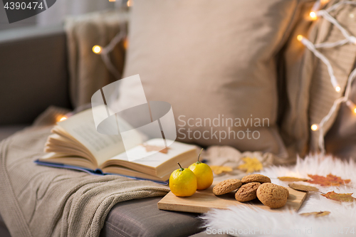 Image of lemons, book, almond and oatmeal cookies on sofa