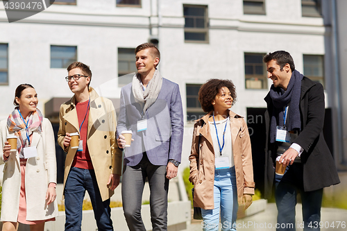 Image of office workers with coffee on city street