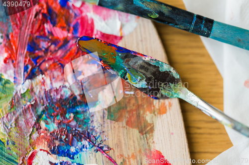 Image of palette knife or painting spatula and paintbrush