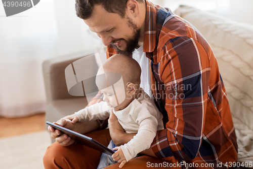 Image of happy father and baby boy with tablet pc at home