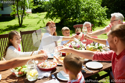 Image of happy family having dinner or summer garden party