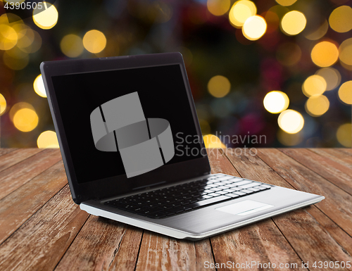 Image of laptop with black screen over christmas lights