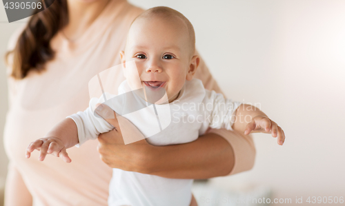 Image of close up of mother with little baby boy at home