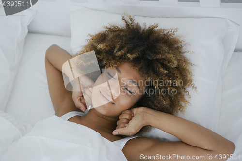 Image of Charming woman awakening happily