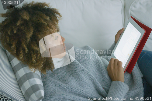 Image of Casual woman spending time with tablet