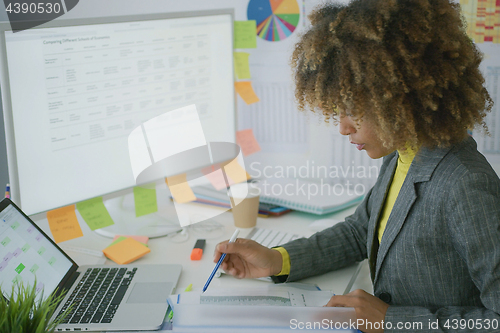 Image of Young businesswoman working with documents