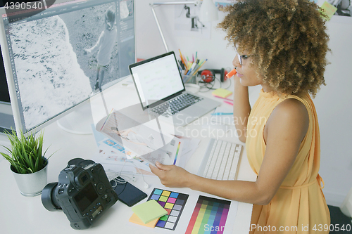 Image of Pensive editor exploring photos