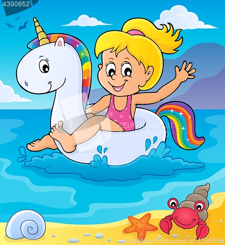 Image of Girl floating on inflatable unicorn 2