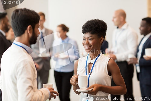 Image of business people with conference badges and coffee