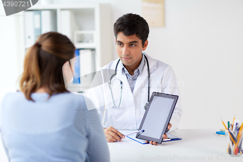 Image of doctor showing tablet pc to patient at clinic