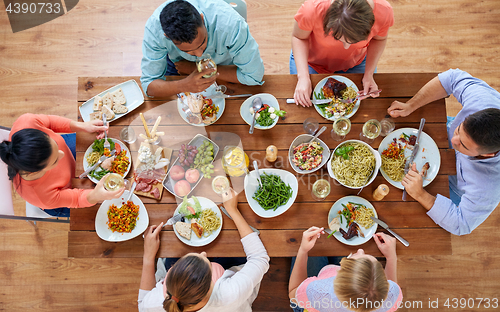 Image of group of people eating at table with food