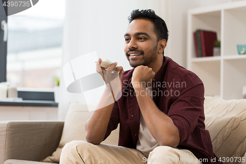 Image of man using voice command recorder on smartphone