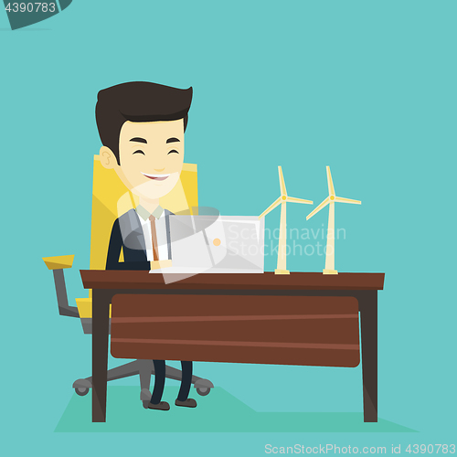 Image of Man working with model of wind turbines.