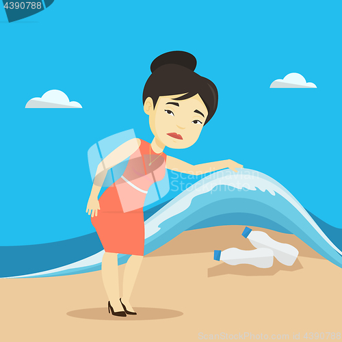 Image of Woman showing plastic bottles under sea wave.