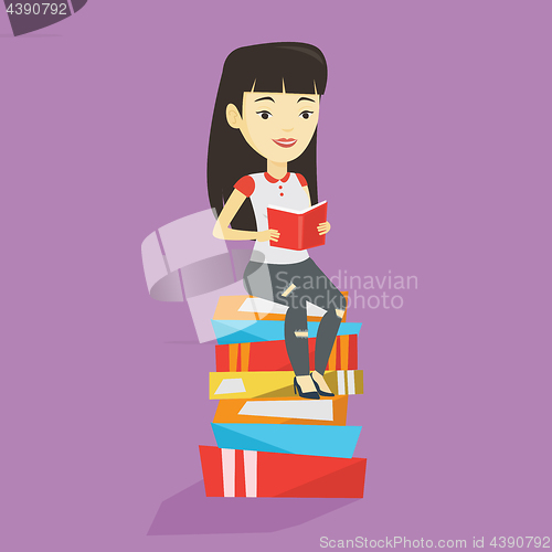 Image of Student sitting on huge pile of books.