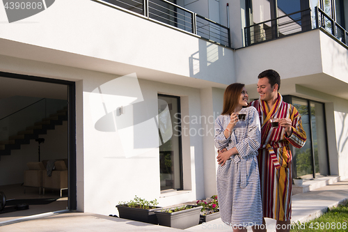 Image of Young beautiful couple in bathrobes