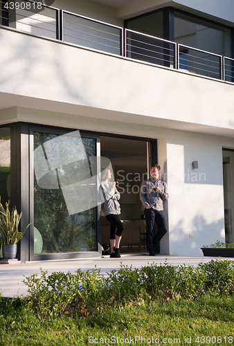 Image of couple enjoying on the door of their luxury home villa