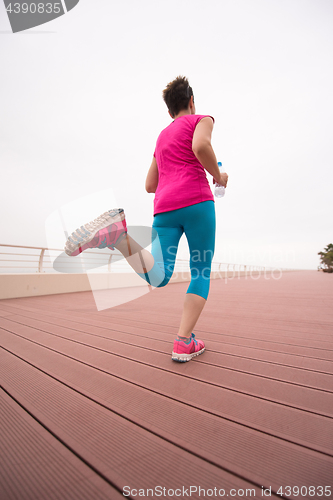 Image of woman busy running on the promenade