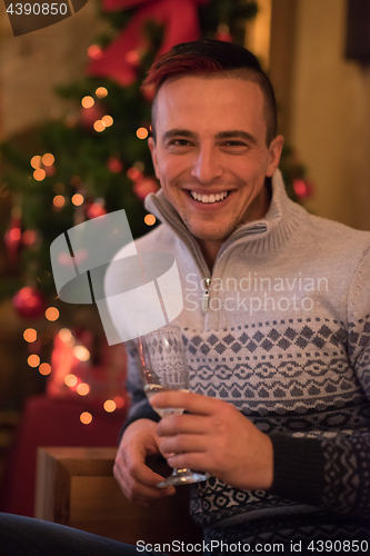 Image of Happy young man with a glass of champagne