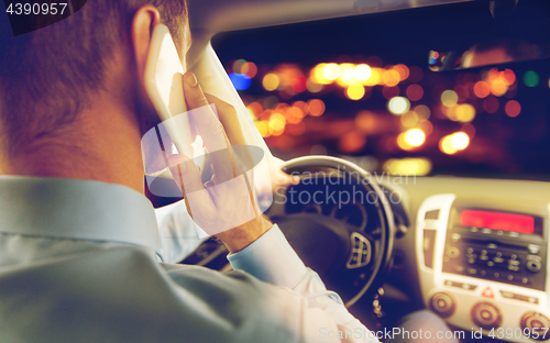 Image of close up of man driving car calling on smartphone