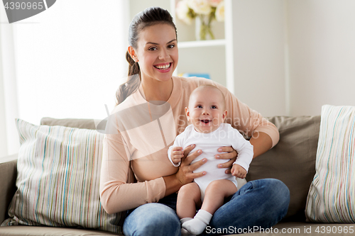 Image of happy mother with little baby boy at home