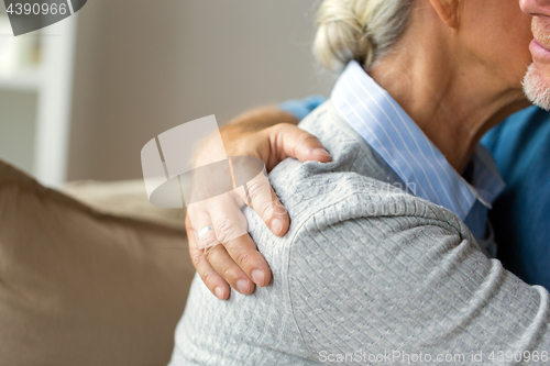 Image of close up of married senior couple hugging