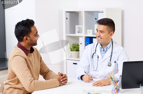 Image of happy doctor and male patient meeting at clinic