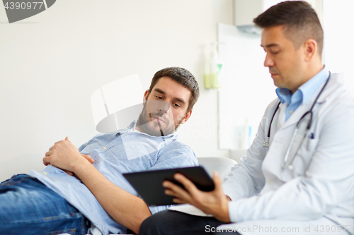 Image of doctor and man with health problem at hospital