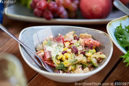 Image of smoked chicken salad in bowl on wooden table