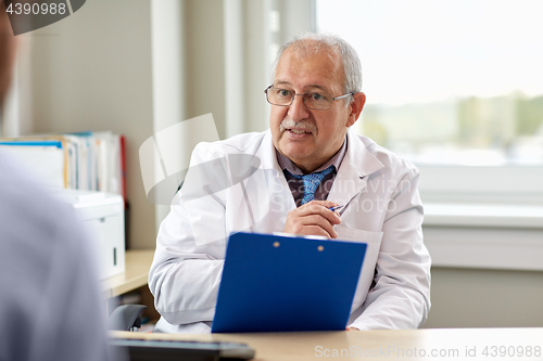 Image of senior doctor talking to male patient at hospital