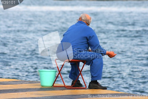 Image of senior man fishing