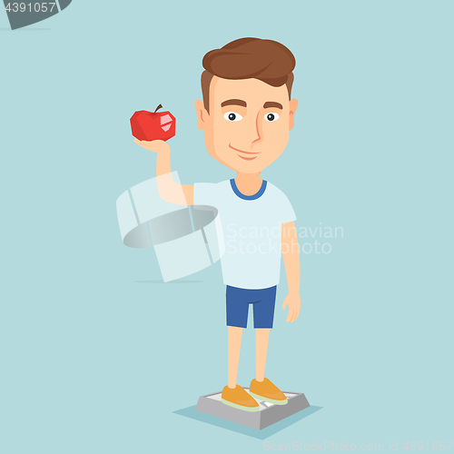 Image of Man standing on scale and holding apple in hand.