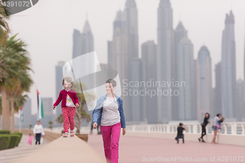 Image of mother and cute little girl on the promenade