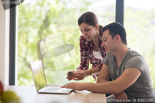 Image of happy young couple buying online