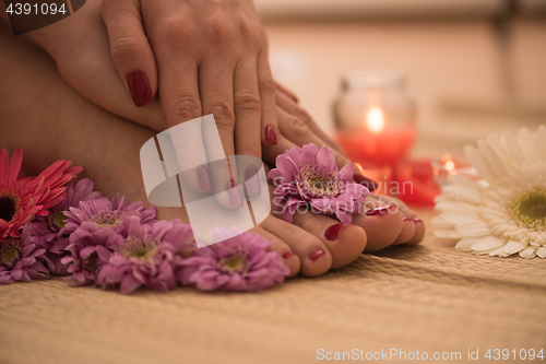 Image of female feet and hands at spa salon