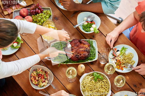 Image of group of people eating chicken for dinner