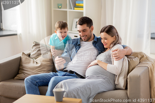 Image of happy family with smartphone at home