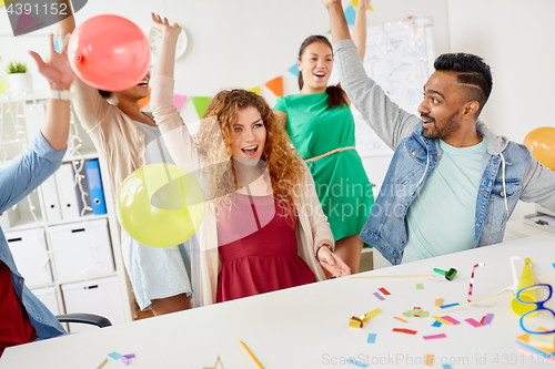 Image of happy team having fun at office party