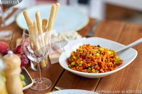 Image of vegetable salad in bowl on wooden table