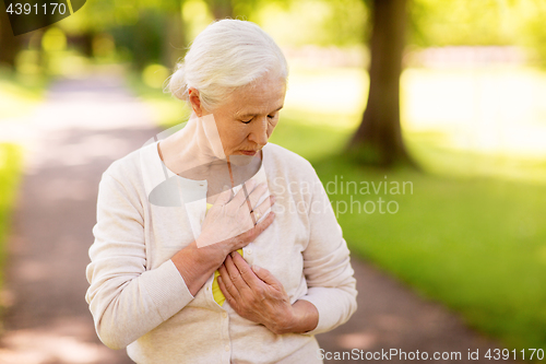 Image of senior woman feeling sick at summer park