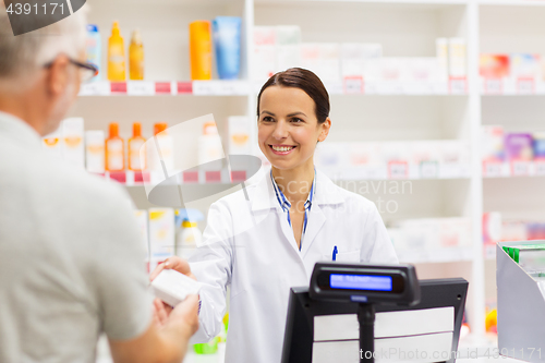 Image of apothecary selling drug to senior man at pharmacy