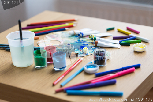 Image of palette, brushes and paint tubes on table