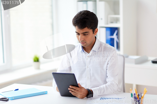 Image of businessman working with tablet pc at office